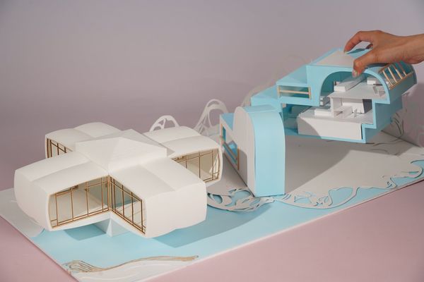 Two architectural models on a layered paper base